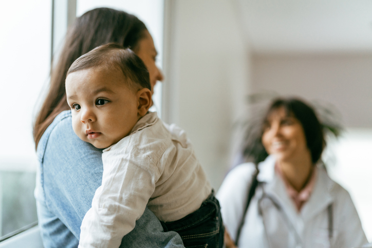 Mother and infant with clinic staff
