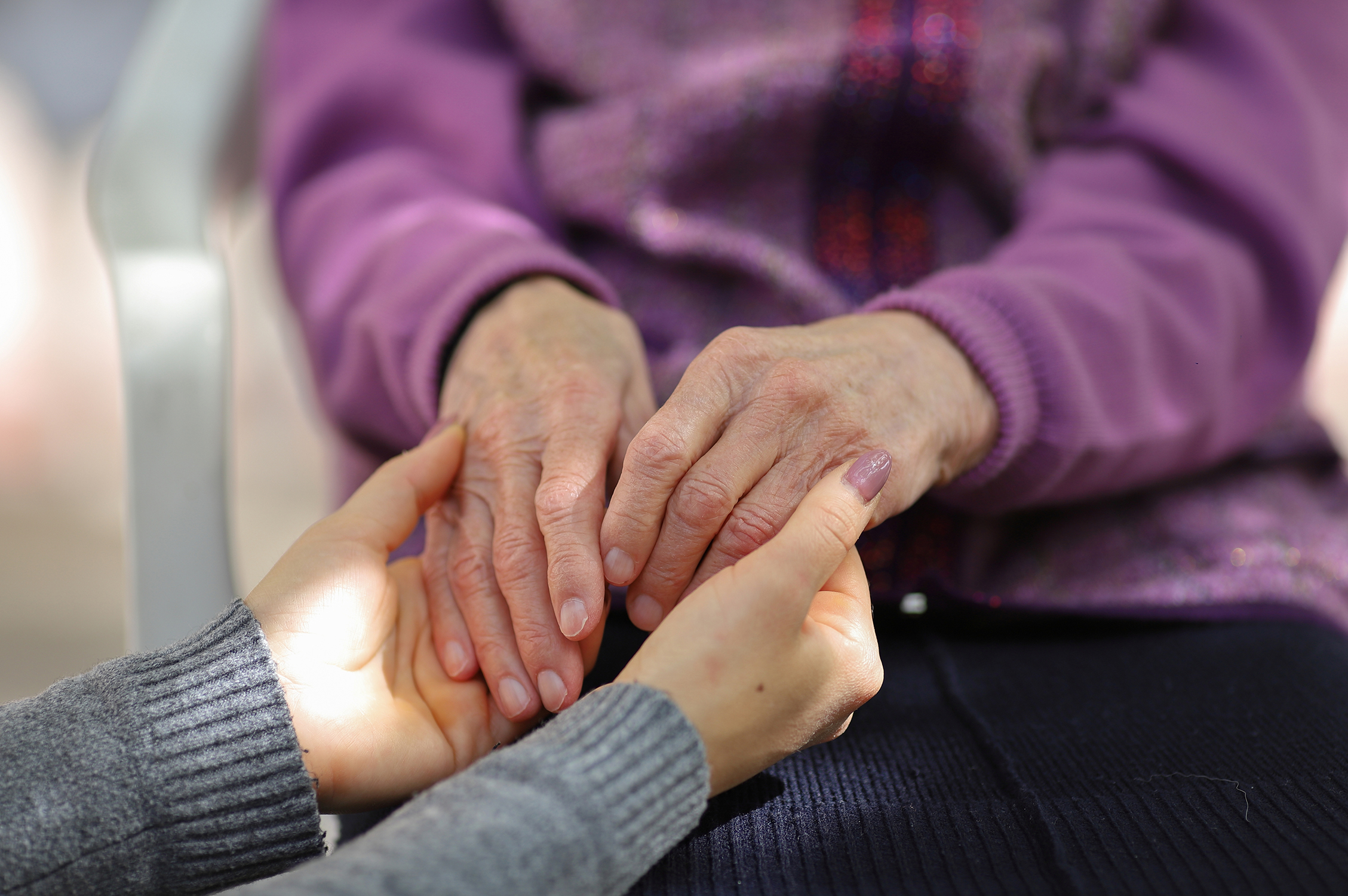 Person holding another person's hands